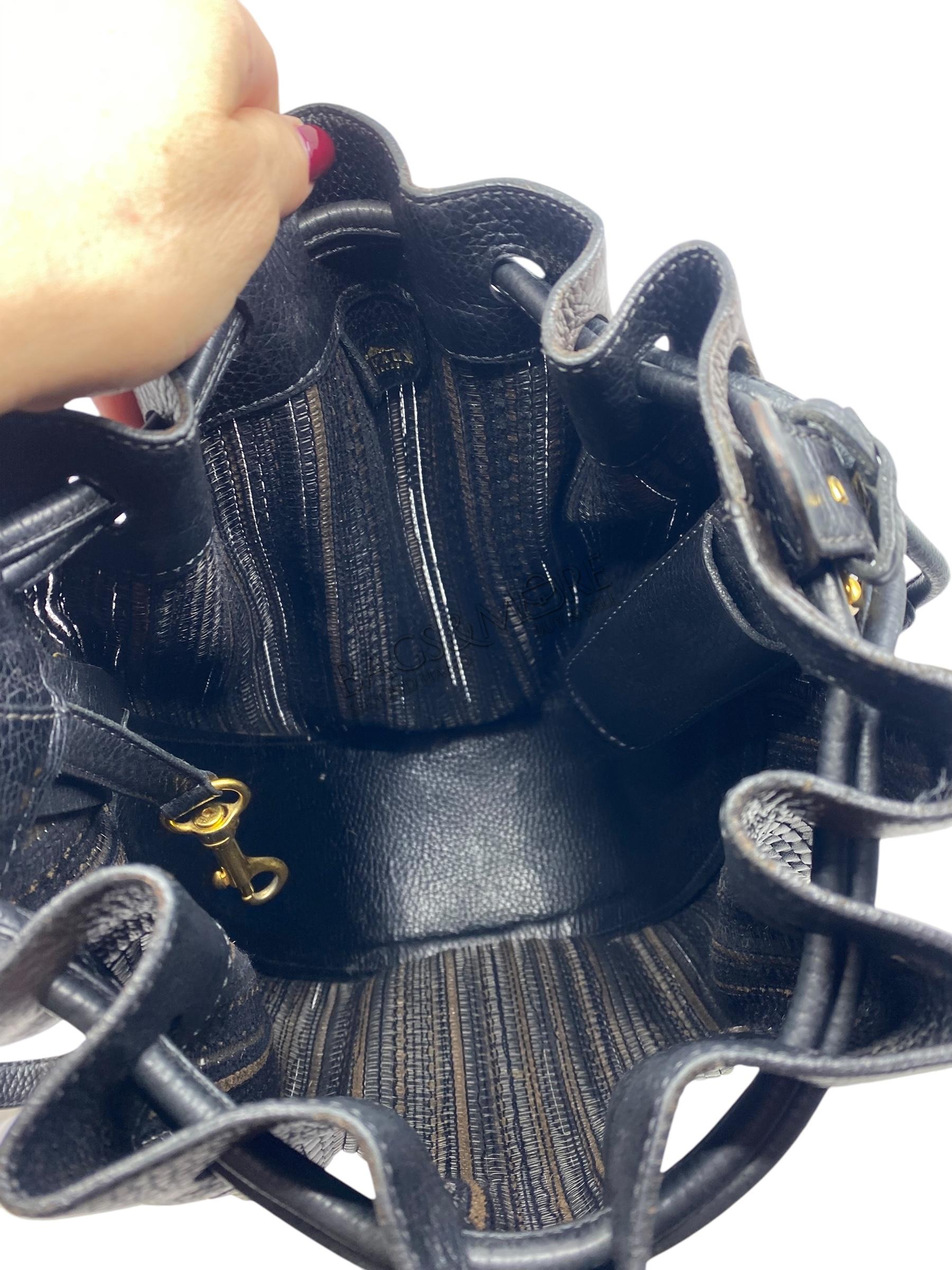 Delvaux Tabarin PM toile de cuir kleuren bruin en zwart met golden hardware